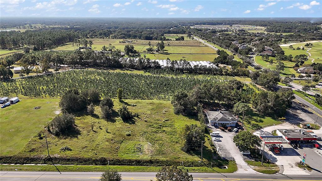 An aerial view shows a vacant lot next to a gas station and agricultural fields — SR-44, SORRENTO, FL