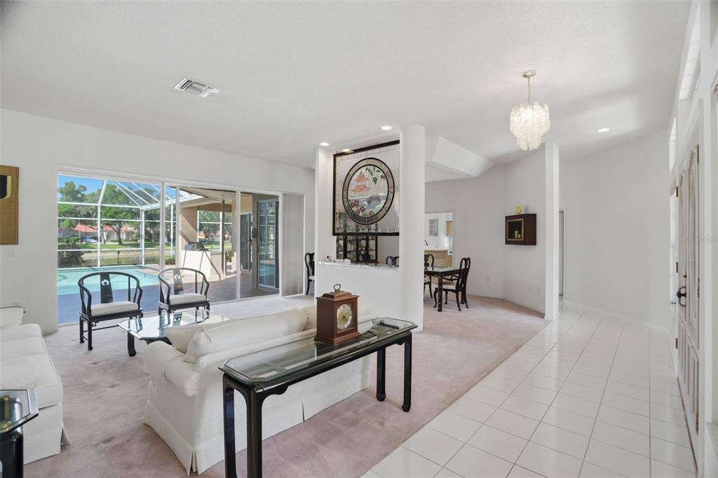 A single-story brick house with a three-car garage and a paved driveway under construction — 3166 STERLING STREET, TARPON SPRINGS, FL