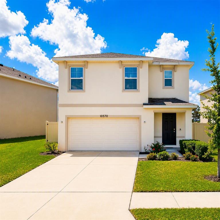 A kitchen features white cabinets, dark granite countertops, a center island, and three bar stools — 10570 PENNY GALE LOOP, SAN ANTONIO, FL
