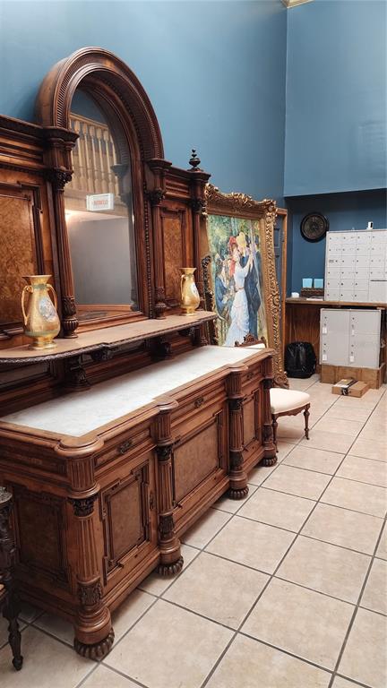 A large antique wooden sideboard with a marble top and mirror stands in a room — 101 W OAK STREET UNIT 101, ARCADIA, FL