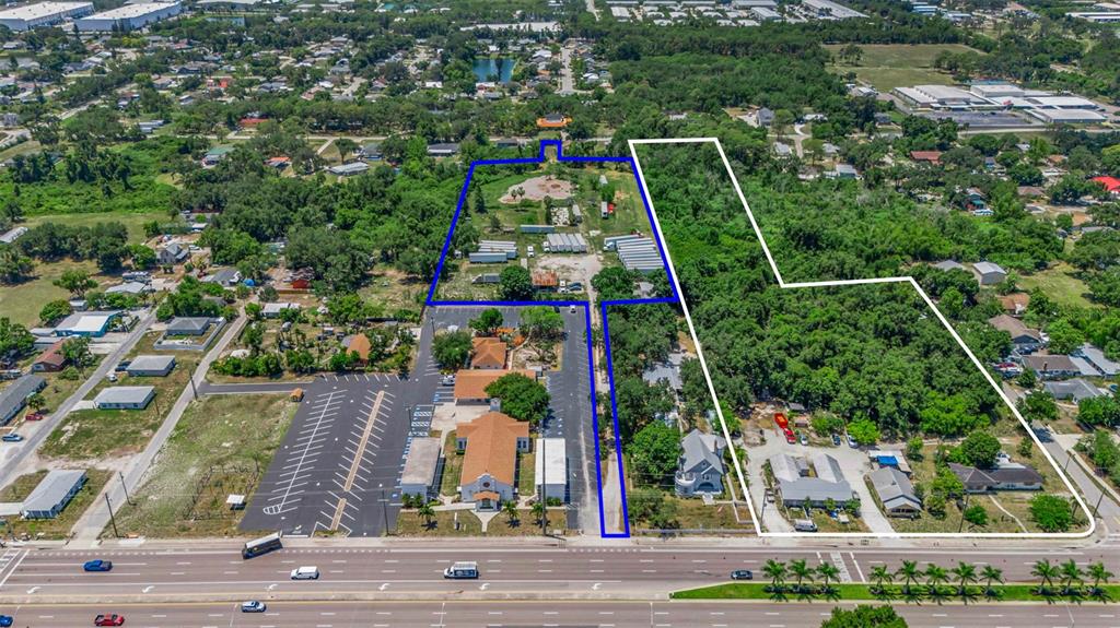 An aerial view shows two adjacent parcels of land outlined in blue and white — 2008 53RD AVENUE E, BRADENTON, FL