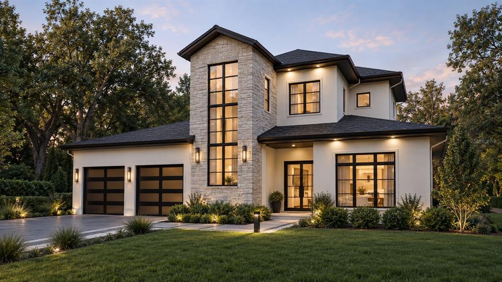 A two-story modern home with a stone facade, dark-framed windows, and a three-car garage — 2119 HOWARD DRIVE, WINTER PARK, FL