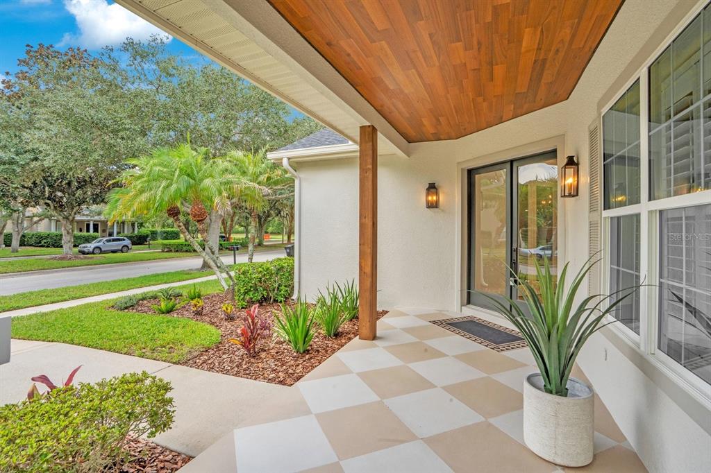 A single-story house with a light-colored exterior, a front porch, and a landscaped yard — 9589 PINE LILY STREET, ORLANDO, FL