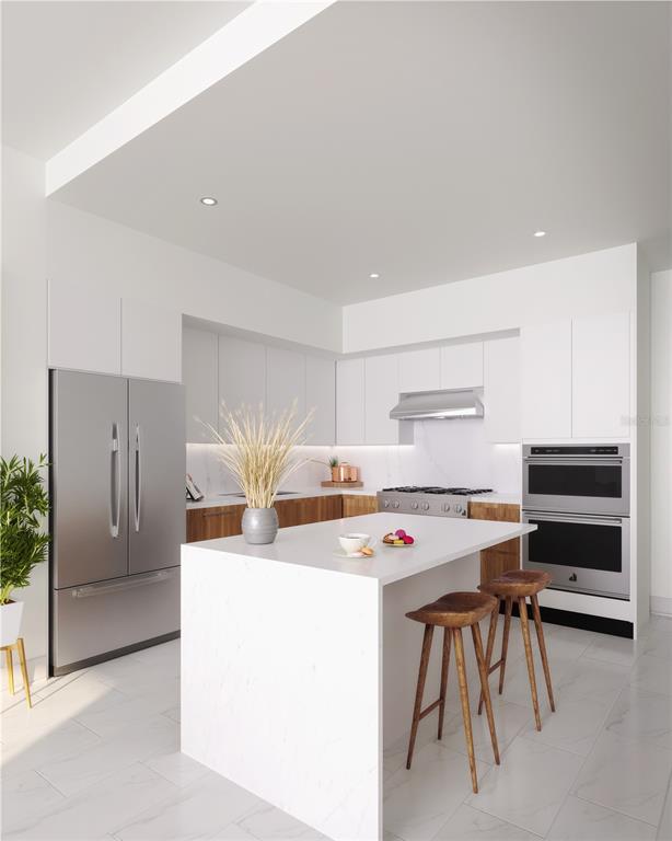 This is a rendering of a modern kitchen featuring white cabinets, stainless steel appliances, and an island — 400 CENTRAL AVENUE UNIT 2208, ST PETERSBURG, FL