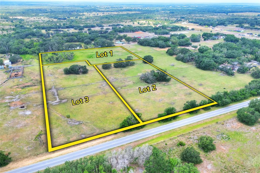 An aerial view shows three adjacent plots of land outlined in yellow near a road — 0 S CR 39, LITHIA, FL