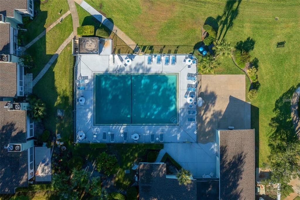 An aerial view shows a rectangular swimming pool surrounded by a patio and lounge chairs — 515 MIDWAY DRIVE UNIT A, OCALA, FL