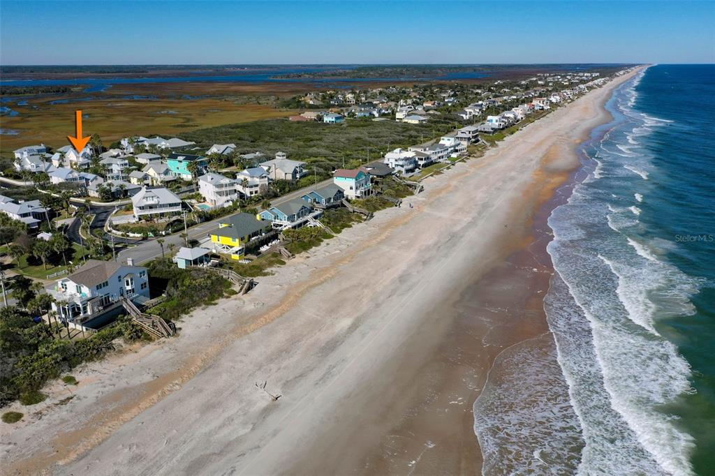 An aerial view shows a coastal neighborhood with houses situated along a sandy beach — 252 GULL CIRCLE, PONTE VEDRA, FL