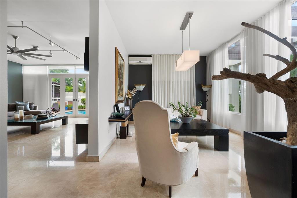A bright living room features light tile floors, a white armchair, and a large driftwood sculpture — PR 8860 km 1.6 KM  1.6, TRUJILLO ALTO, PR