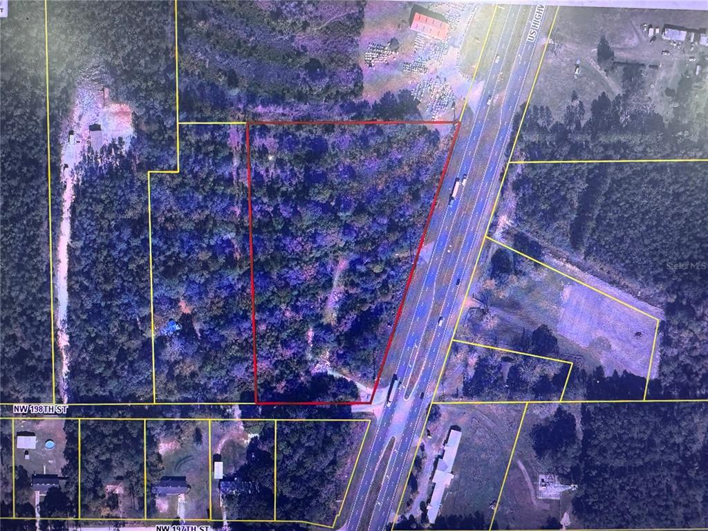 This is an aerial map showing a wooded lot outlined in red next to a highway — 19978 N HIGHWAY 301, STARKE, FL