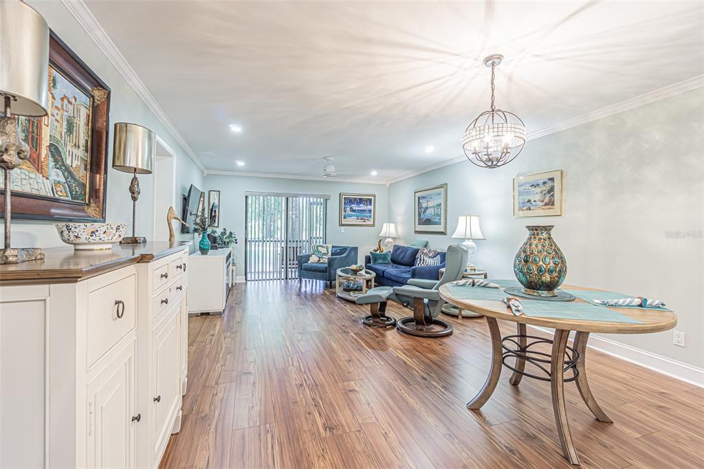 A kitchen features white cabinetry, stainless steel appliances, a marble-patterned island, and white tile flooring — 3505 TARPON WOODS BOULEVARD UNIT G405, PALM HARBOR, FL