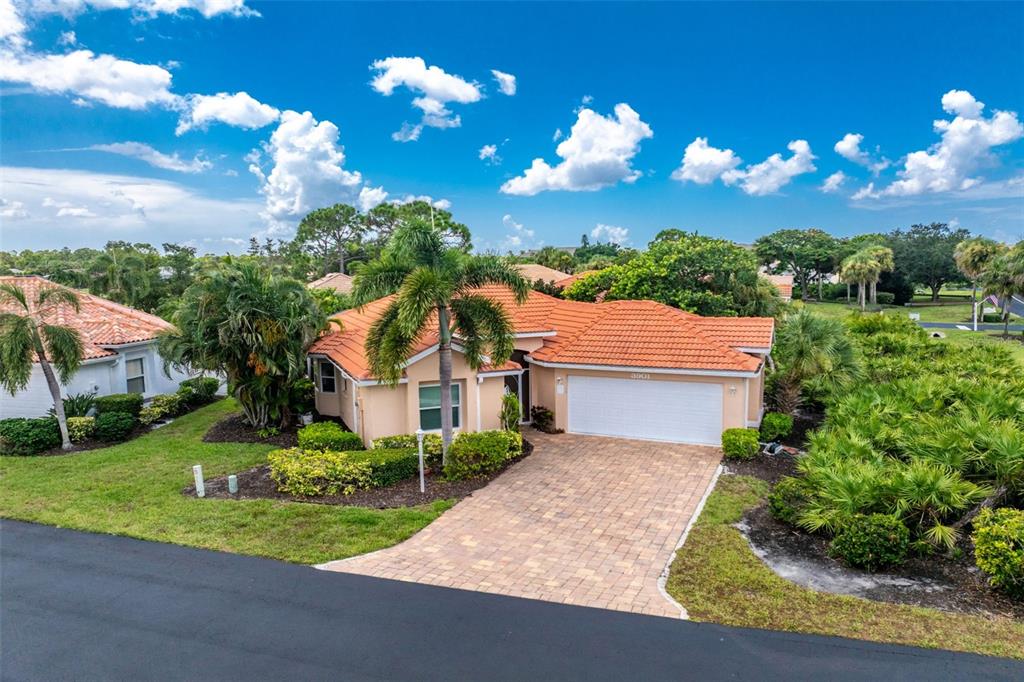 An aerial view of a single-story house with a tile roof and a paved driveway — 3901 CAPE COLE BOULEVARD, PUNTA GORDA, FL