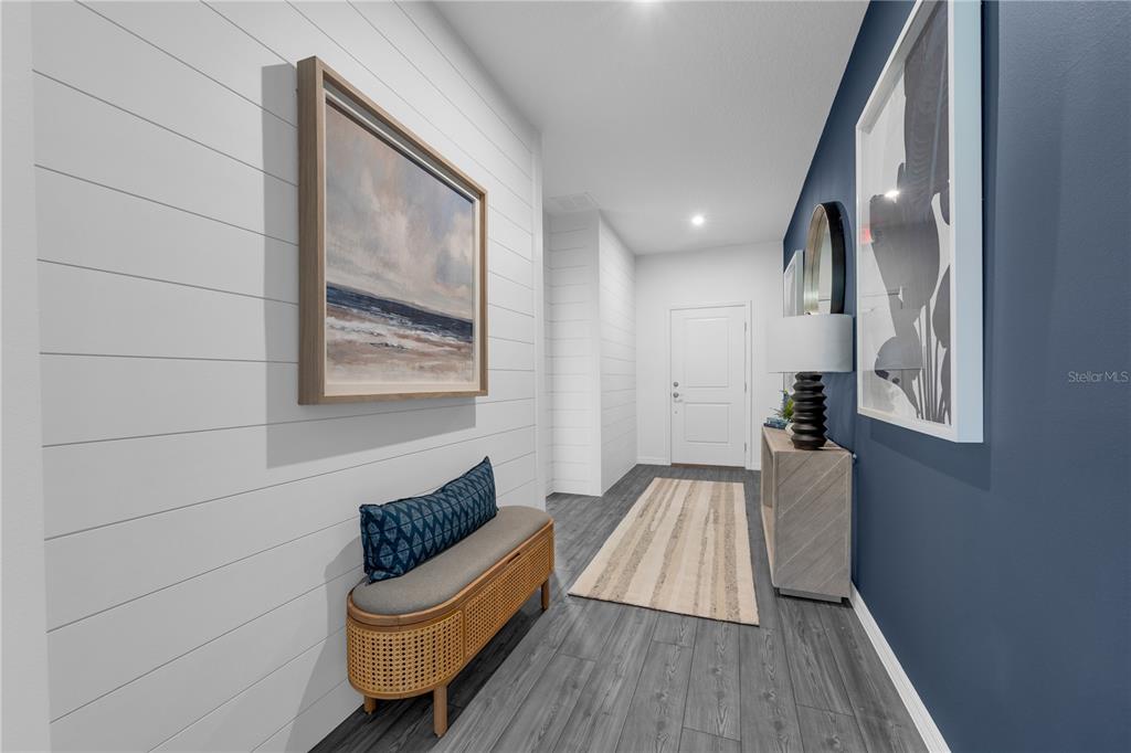 A hallway features white shiplap walls, a blue accent wall, and dark wood-look flooring — 5824 CLIFFBOW LOOP, LEESBURG, FL