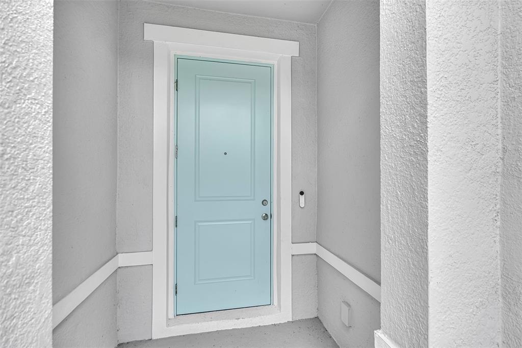 A light blue front door with white trim is set within a recessed entryway — 9810 EVENTIDE TRAIL, PARRISH, FL