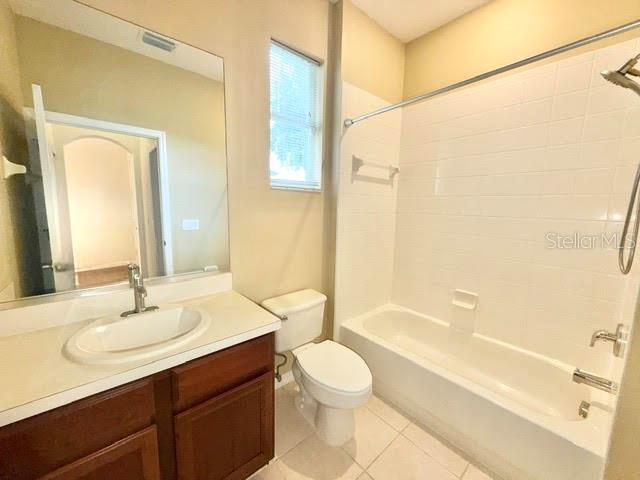 A bathroom featuring a vanity with a sink, a toilet, and a shower-tub combination — 4301 HEIRLOOM ROSE PLACE, OVIEDO, FL