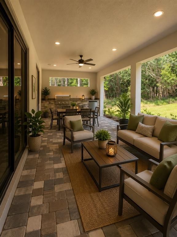 A covered outdoor patio features a dining area, a grill station, and comfortable lounge seating — 5601 SUMMIT VIEW DRIVE, BROOKSVILLE, FL