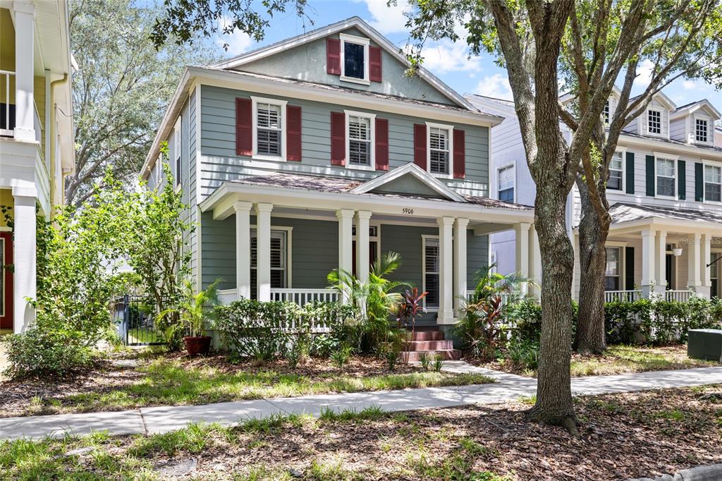 A two-story house with blue siding, red shutters, and a front porch with white columns — 5906 BEACONPARK STREET, LITHIA, FL