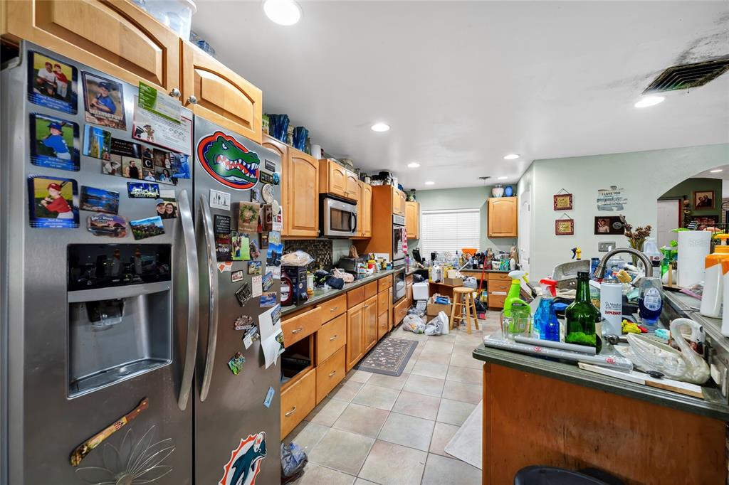 A kitchen with wood cabinets, stainless steel appliances, and tile flooring — 3126 S OSCEOLA AVENUE, ORLANDO, FL