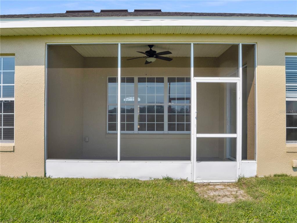 A kitchen features dark wood cabinets, granite countertops, and stainless steel appliances — 6260 SW 90TH STREET, OCALA, FL