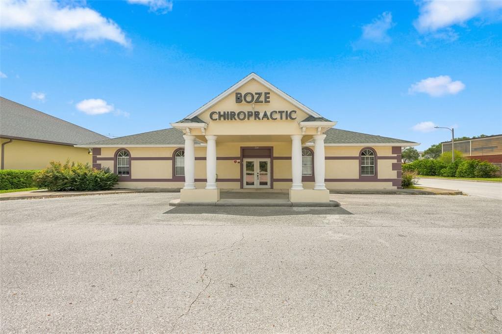 The exterior of a single-story commercial building with a covered entrance and columns — 224 MARINER BOULEVARD, SPRING HILL, FL
