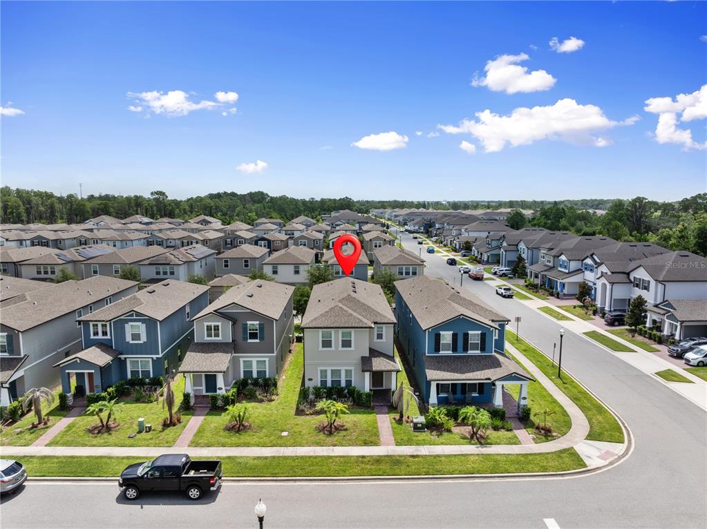 An aerial view shows a suburban neighborhood with a red pin marking a two-story house — 12597 ENCORE AT OVATION WAY, WINTER GARDEN, FL