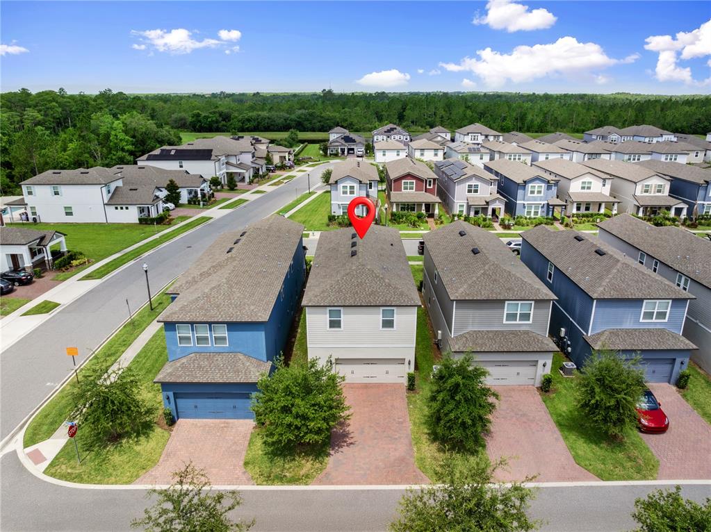 An aerial view shows a row of suburban houses with a red pin marking one — 12597 ENCORE AT OVATION WAY, WINTER GARDEN, FL