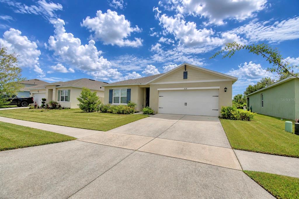 A single-story suburban house with a two-car garage and a concrete driveway — 5628 SILTSTONE STREET, LAKELAND, FL