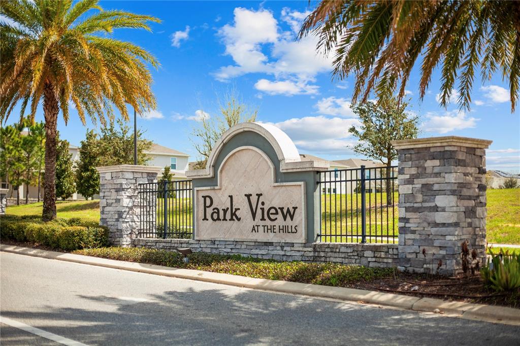 A stone monument sign for Park View at the Hills stands beside a palm tree — 951 VINEYARD RIDGE ROAD, MINNEOLA, FL