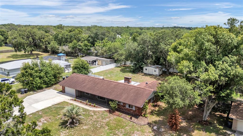 A single-story brick house with a brown roof sits on a grassy lot — 3180 FLAMINGO LANE, MULBERRY, FL