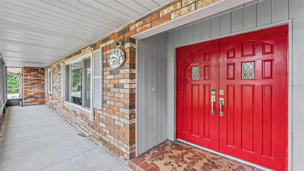 An aerial view shows a single-story brick house with a brown roof and backyard — 3180 FLAMINGO LANE, MULBERRY, FL