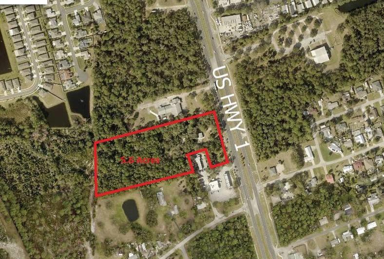 An aerial view shows a 5.6-acre plot of land outlined in red along a highway — 3258 S RIDGEWOOD AVENUE, EDGEWATER, FL