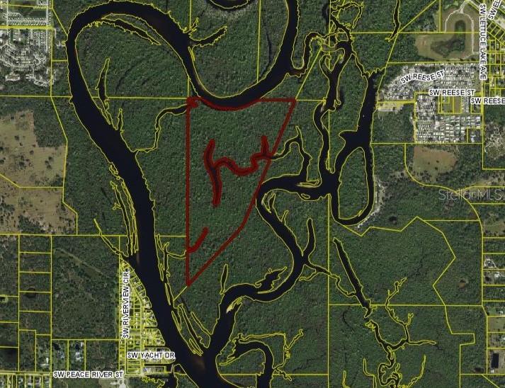 An aerial map shows a triangular property boundary outlined in red surrounded by a river — SW CO ROAD 761 UNIT A, ARCADIA, FL