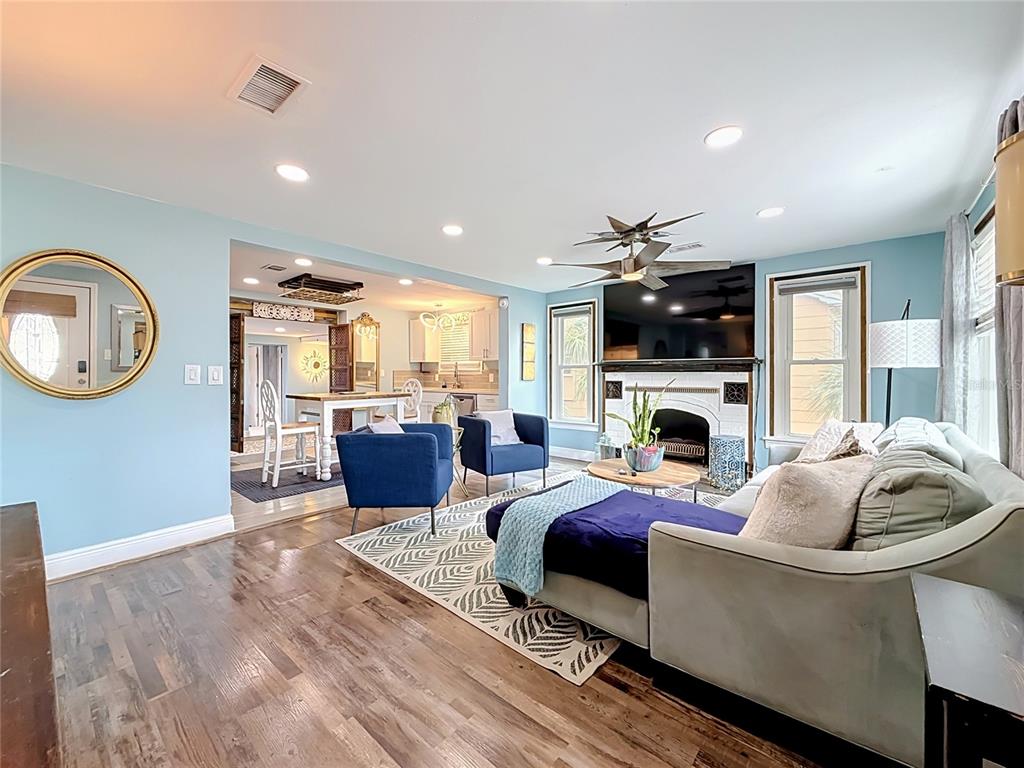 A kitchen features a wooden dining table, stainless steel appliances, and light blue walls — 4831 FAIRFIELD AVENUE S, ST PETERSBURG, FL