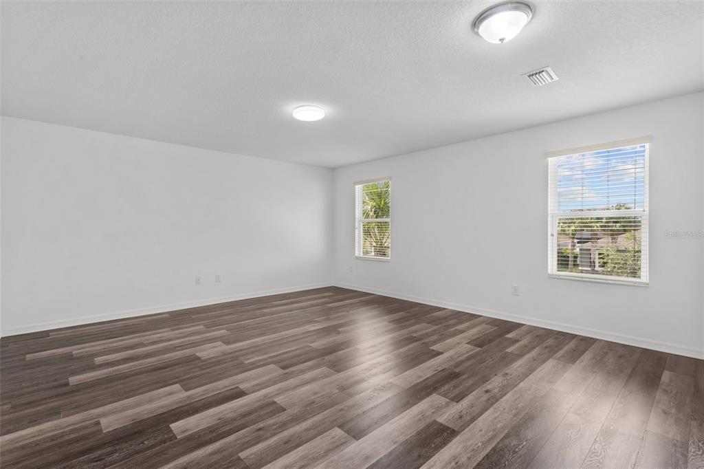 An entryway features a white front door, a closet door, and stairs with wood treads — 12124 LAKE BOULEVARD, NEW PORT RICHEY, FL