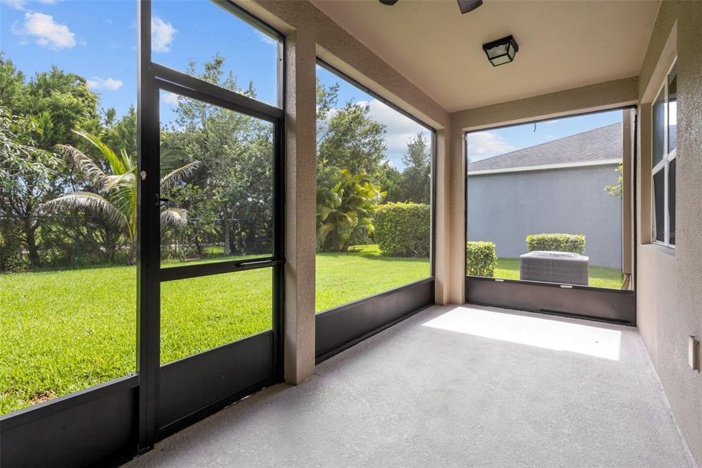 A kitchen features wood cabinets, granite countertops, stainless steel appliances, and a central island — 12124 LAKE BOULEVARD, NEW PORT RICHEY, FL