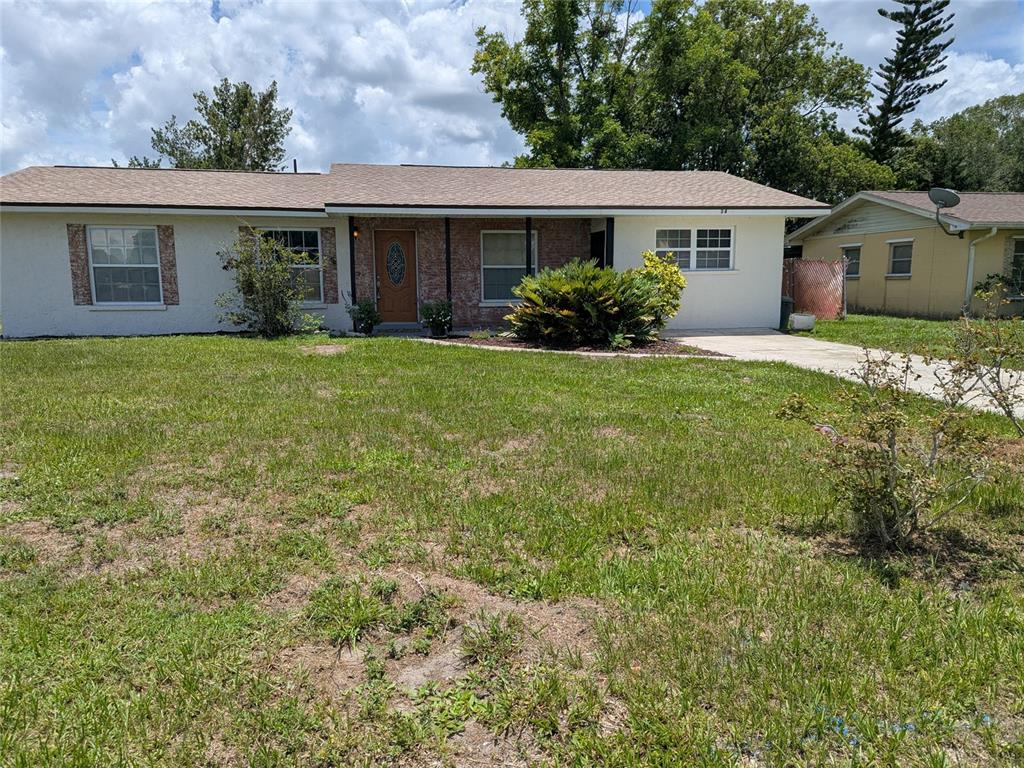 A single-story house with a light-colored exterior, brick accents, and a front lawn — 34 SEVILLA AVENUE, ARCADIA, FL