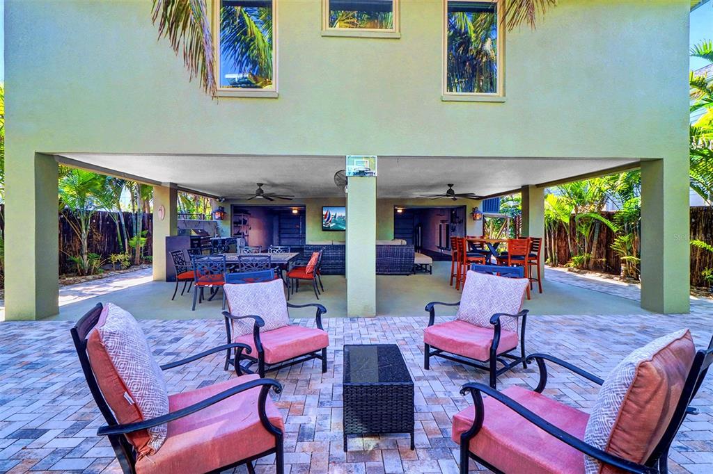 A covered patio area features a paved floor, outdoor seating, and a dining set — 15517 GULF BOULEVARD, REDINGTON BEACH, FL