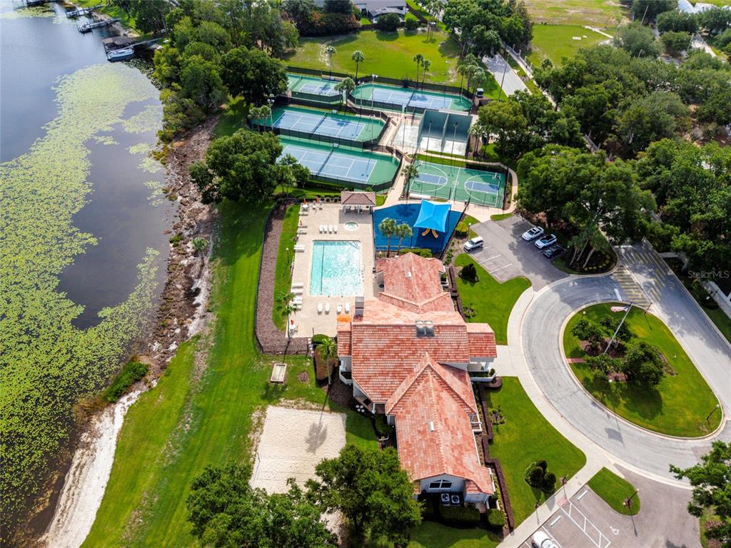 A single-story house with a red tile roof, beige stucco walls, and a manicured hedge — 6350 PARSON BROWN DRIVE, ORLANDO, FL