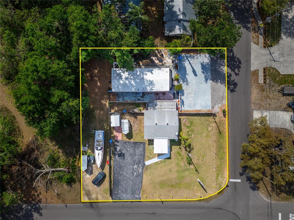 An aerial view shows a house with a driveway, a boat, and a large yard — 126 RIDGEWOOD AVENUE, BRANDON, FL