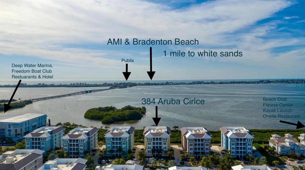 This is an aerial view of a waterfront residential complex with labeled local landmarks — 384 ARUBA CIRCLE UNIT 102, BRADENTON, FL