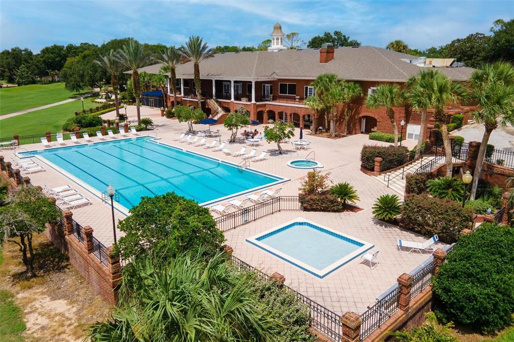 An aerial view shows a large brick building with a swimming pool and patio area — 6115 LANDINGS BOULEVARD, LADY LAKE, FL