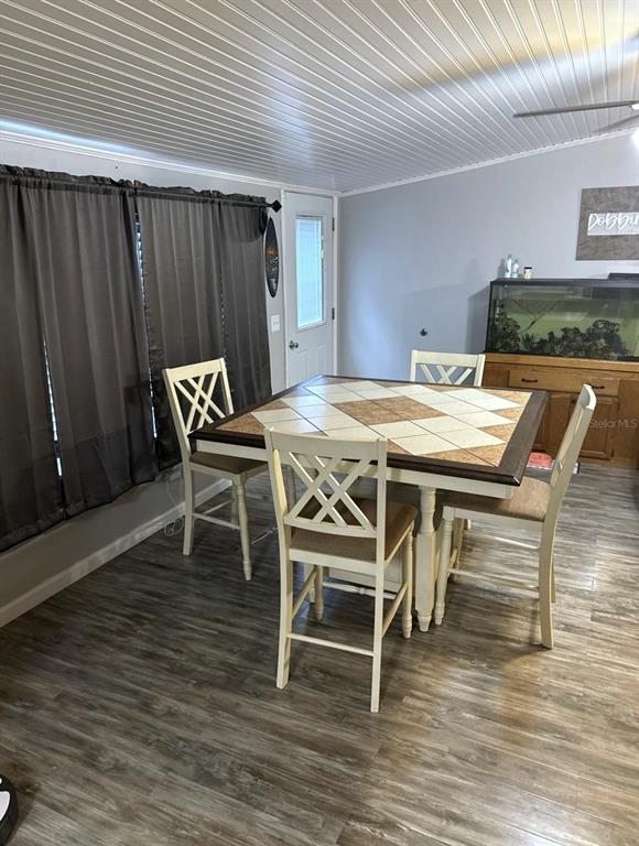 A dining area features a tiled square table, four chairs, and wood-look flooring — 172 E COWPEN LAKE POINT ROAD, HAWTHORNE, FL