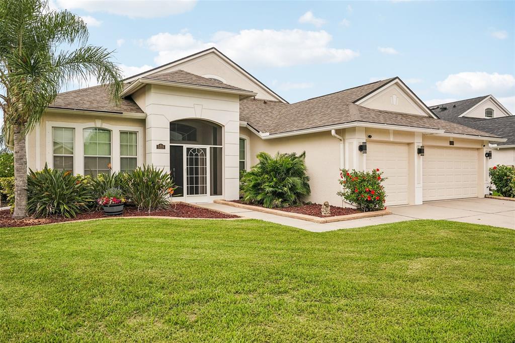 A single-story house with a beige stucco exterior, a two-car garage, and a front lawn — 5319 120TH AVENUE E, PARRISH, FL