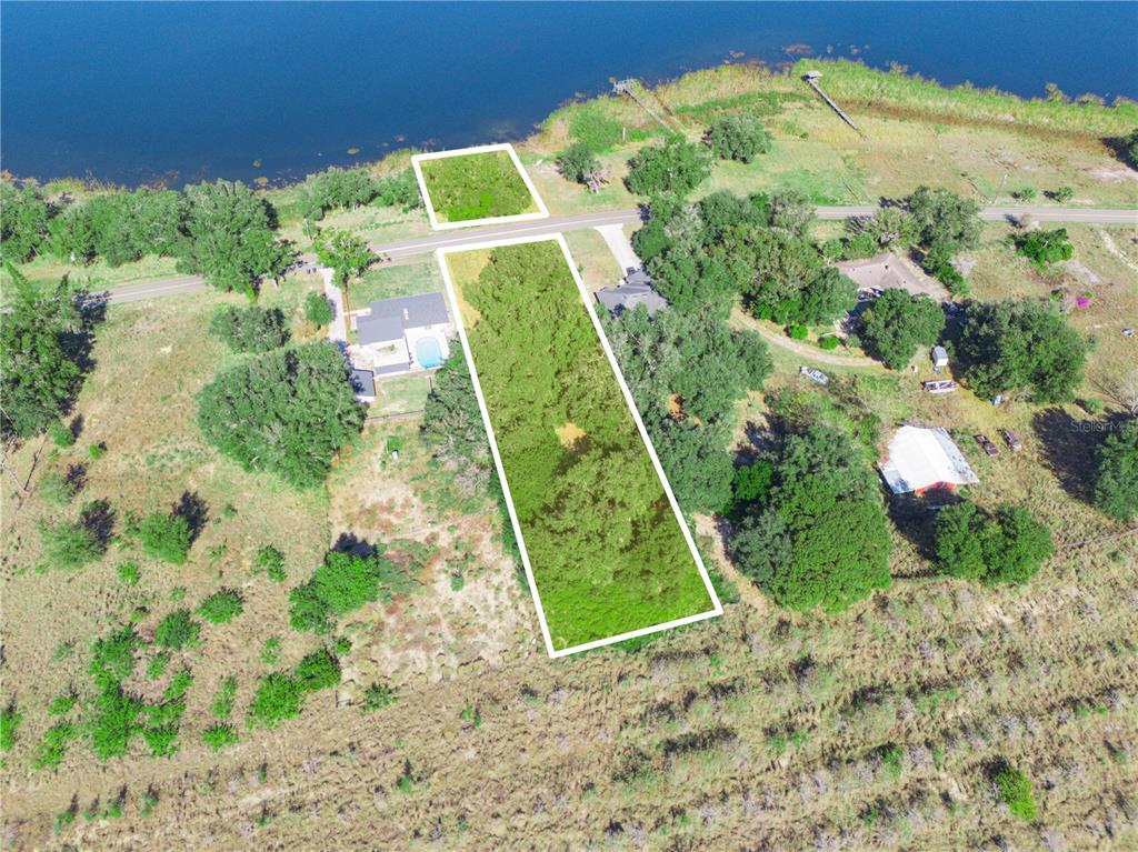 An aerial view shows two adjacent land parcels outlined in white near a lake — 0 LAKE MABEL LOOP RD, LAKE WALES, FL