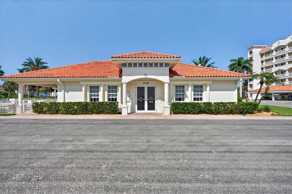A single-story building with a tiled roof and a covered entryway featuring white columns — 108 FOREST HILLS DRIVE, REDINGTON SHORES, FL