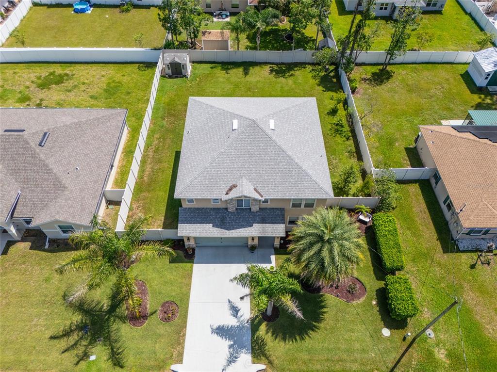 An aerial view shows a two-story house with a gray roof, driveway, and palm trees — 6 RYBARK LANE, PALM COAST, FL