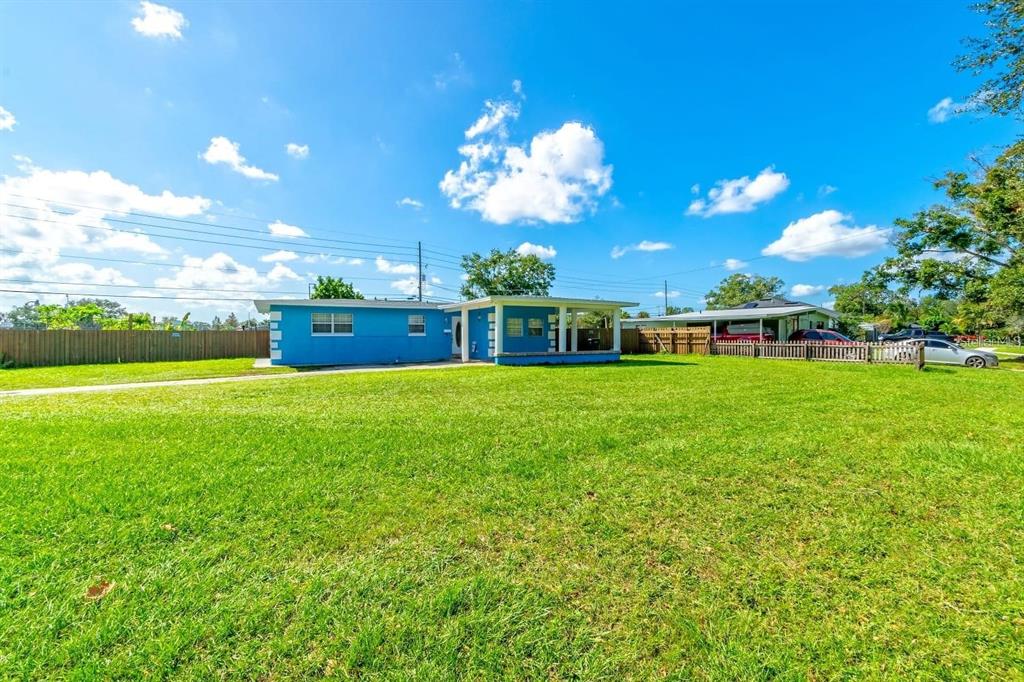 A blue single-story house with a flat roof sits on a large, grassy lot — 804 ENGEL DRIVE, ORLANDO, FL