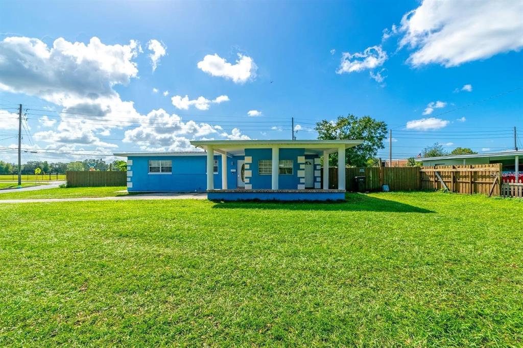 A bright blue single-story house with a covered front porch sits on a grassy lot — 804 ENGEL DRIVE, ORLANDO, FL