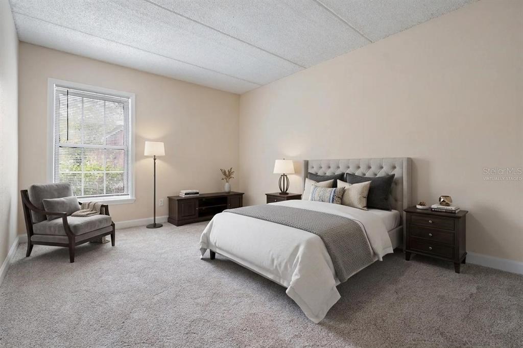 An empty room with beige tile flooring, light-colored walls, and two open doorways — 8565 12TH WAY N UNIT A, ST PETERSBURG, FL