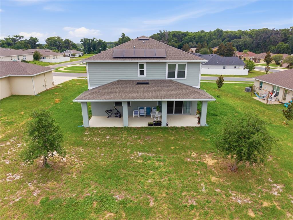 An aerial view of the back of a two-story house with a covered patio — 31707 BROADWATER AVENUE, LEESBURG, FL
