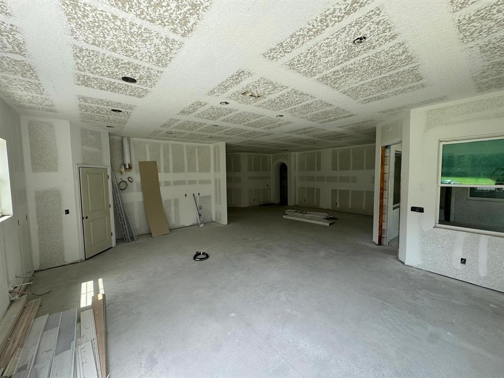 An unfinished room with drywall, a textured ceiling, and recessed lighting under construction — 6701 OLD MELBOURNE HIGHWAY UNIT A, ST CLOUD, FL